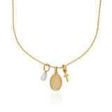 Cross, pearl, and dotted disc charm necklace