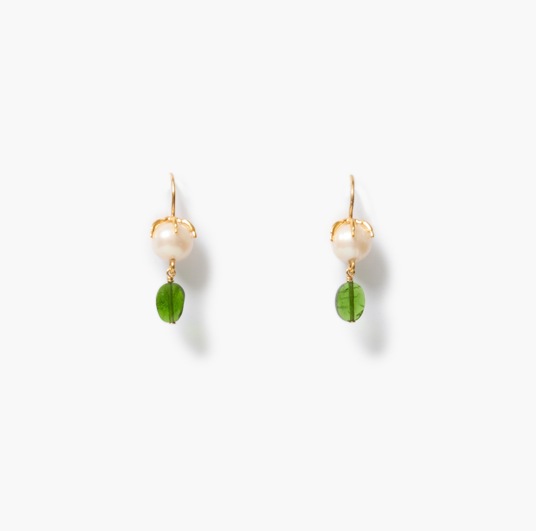 A pair of gold-tone dangle earrings featuring a white pearl and a peridot charm, displayed on a clean white background.