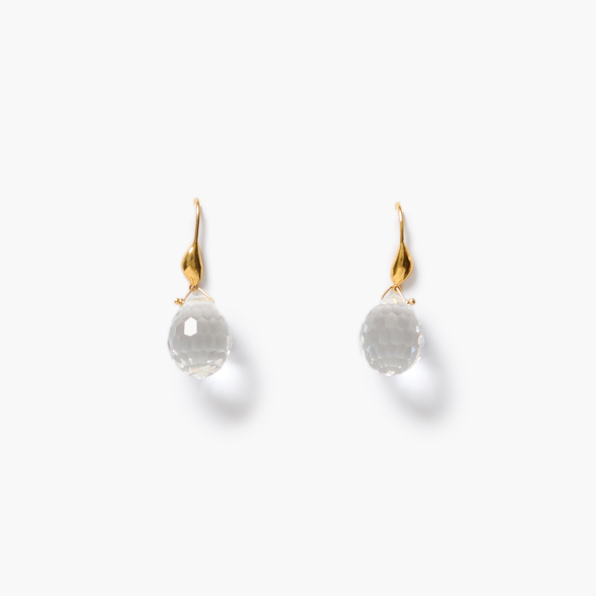 A pair of gold tone earrings with faceted, clear crystal briolette gemstones, shown on a clean white background.