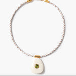 Necklace with a white pendant and peridot inlay on a white background